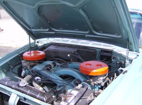 1970 Ford Ranchero - Close-up of a classic car's engine bay, highlighting the dual carburetor setup.