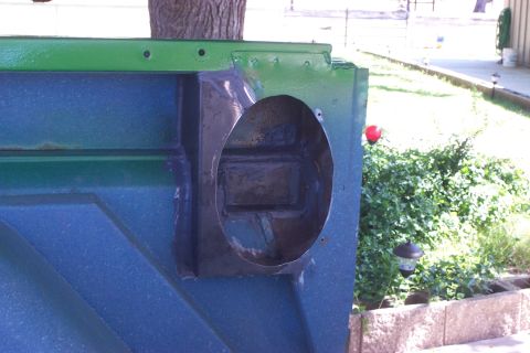 1976 Ford Bronco - Vehicle body panel with a circular cutout, painted blue and green.