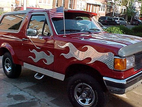 1990 Ford Bronco - This 1990 Ford Bronco is decorated with flame decals and an American flag.