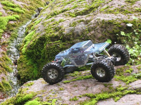 2010 Ford Pickup - Remote control rock crawler navigating a moss-covered rocky terrain.