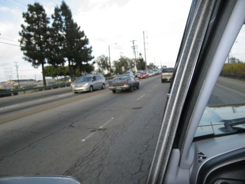 1986 Ford Bronco - Driving in traffic on a multi-lane highway with other vehicles on the road.
