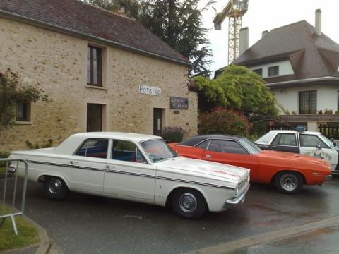 1991 Ford LTD Crown Victoria - Three distinct vehicles, including a vintage police car, are parked in front of a stone building.