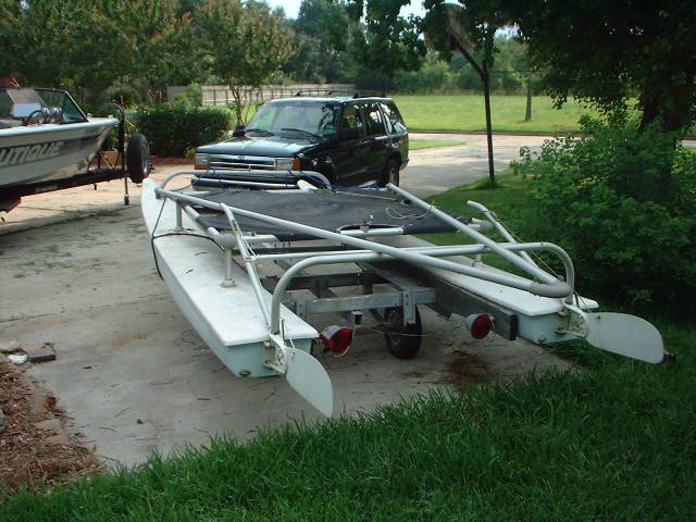 Black SUV parked next to a boat on a trailer. The SUV appears to be a 1996 Ford Explorer