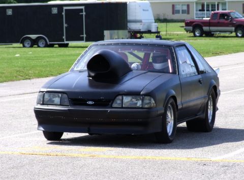 1990 Ford Mustang - A modified Ford Mustang with a prominent hood scoop is ready for a drag race.