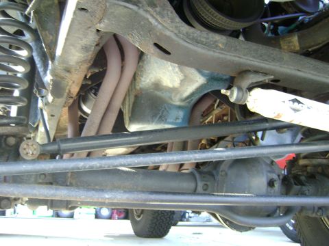 1979 Ford Bronco - A close-up view of the underside of a vehicle, showing various mechanical parts and suspension.