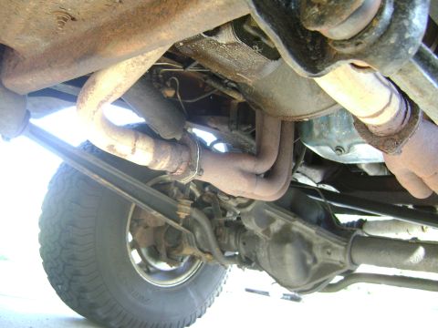 1979 Ford Bronco - The underside of a 1979 Ford Bronco reveals its rear axle, suspension components, and exhaust pipes.