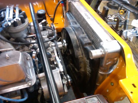 1978 Ford Mustang II - Close-up view of an engine bay chrome valve covers and an aluminum radiator with a fan.