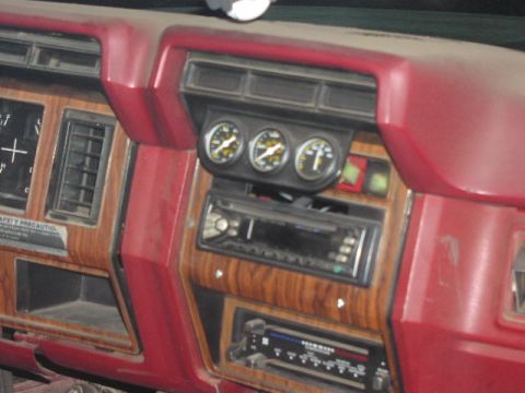 1981 Ford Bronco - Close-up of a vehicle's dashboard, showing gauges and a stereo system.