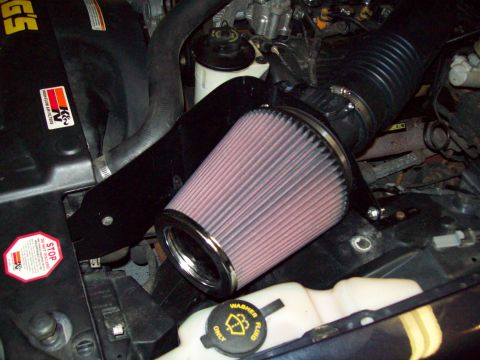 1999 Mercury Grand Marquis - Close-up of an engine bay an aftermarket K&N air filter and intake system.