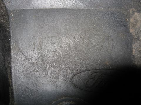 1996 Mercury Grand Marquis - A close-up view of a vehicle part with a Ford logo and stamped identification numbers.