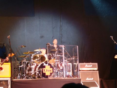 1996 Ford Bronco - A drummer performs with a drum kit and amplifiers on a concert stage.