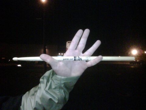1996 Ford Bronco - A Vic Firth drumstick is held horizontally across a person's palm at night.