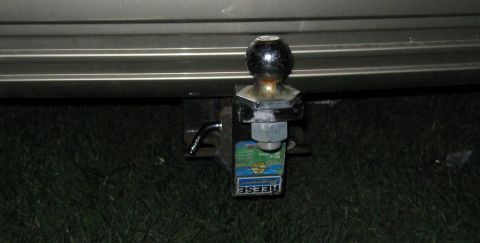 2000 Mercury Grand Marquis - A trailer hitch is attached to the rear of a vehicle, with a Reese sticker visible on the ball mount.