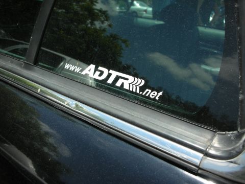 1992 Ford Crown Victoria - A white sticker with the web address www.ADTR.net is affixed to the tinted window of a dark-colored vehicle.