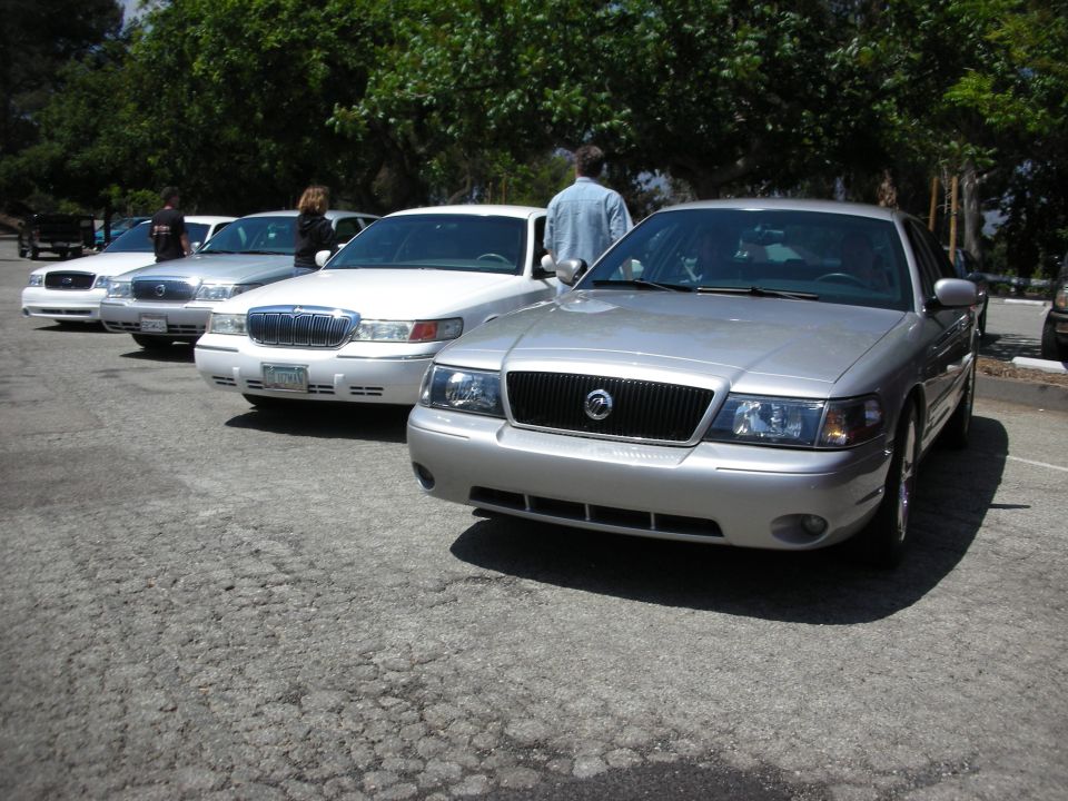 Silver sedan with a black grille and chrome accents parked on asphalt