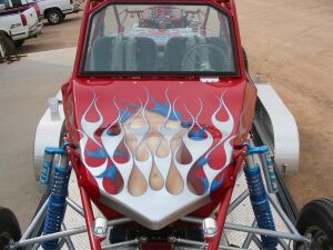 1993 Ford Taurus - Custom red dune buggy with flame graphics is seen from the front.