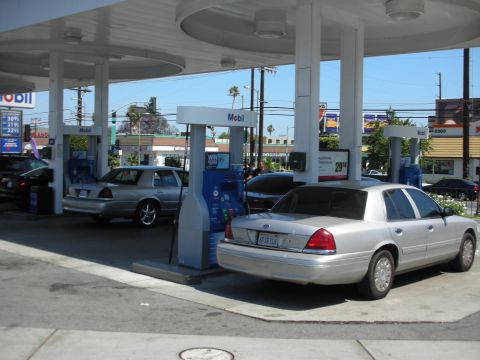 1992 Ford Crown Victoria - Two Ford Crown Victorias at a Mobil gas station on a sunny day.