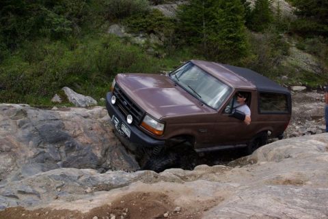 1993 Ford Bronco - This 1993 Ford Bronco tackles a challenging rocky trail, demonstrating its off-road capabilities.