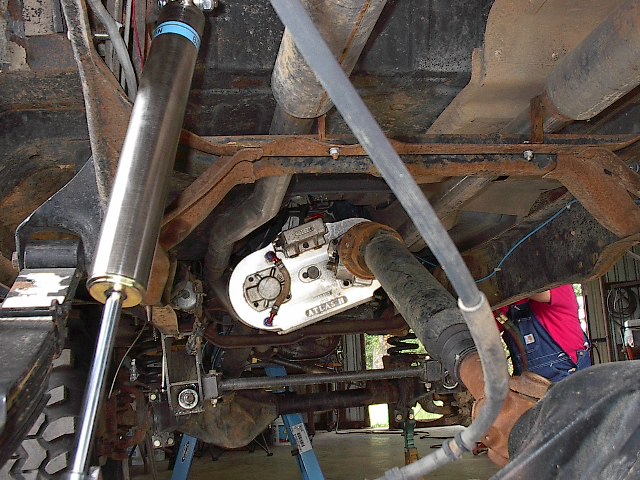 Upper mount needed to be removed and turned down to accept the Bilstien heim joint on top.  You can also see exhaust routing on this pic.
