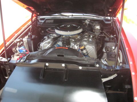 1972 Ford Ranchero - The engine compartment of a vehicle is open, revealing the V8 engine and its associated parts.