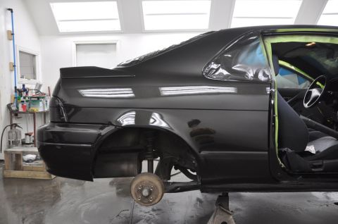 1996 Ford Bronco - Car bodywork being prepared for paint in a workshop setting.