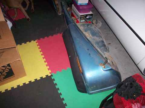 1978 Jeep CJ5 - A blue fender section with an amber light is shown on a floor with colorful interlocking mats.