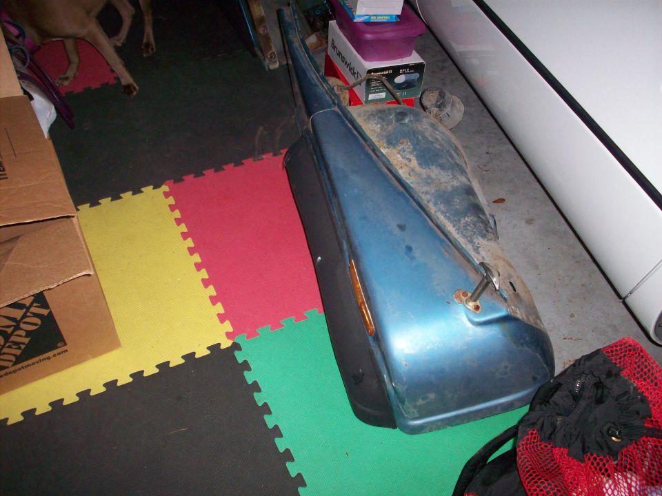 blue fender part with amber light, sitting on interlocking floor mats