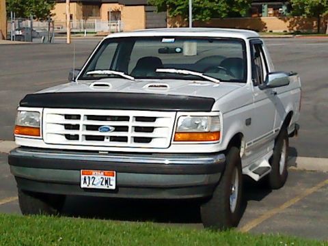 1995 Ford Bronco - This white Ford truck has a distinctive grille and a Utah license plate.