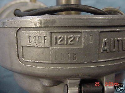 1968 Shelby GT500 - Close-up of a metal distributor cap showing stamped identification codes and partial text.