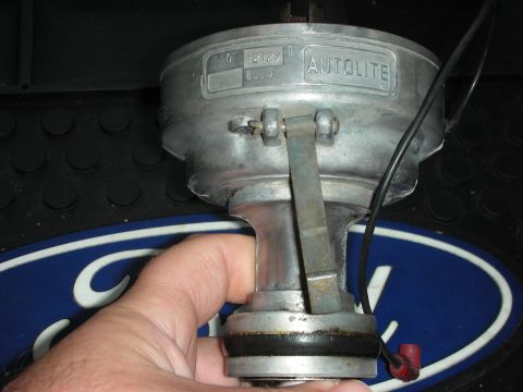 1968 Shelby GT500 - Autolite distributor part with visible stamping and Ford logo in the background.