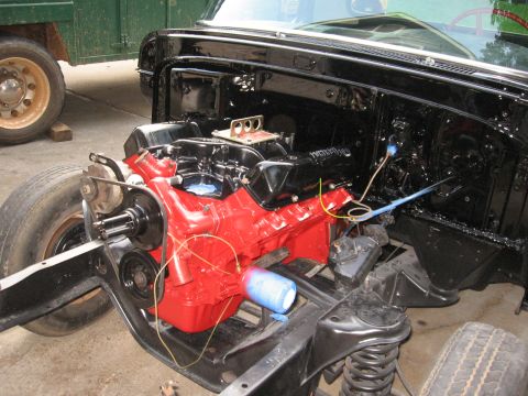 1966 Ford F-100 - Truck engine and chassis during re-assembly, showing the engine block and frame.