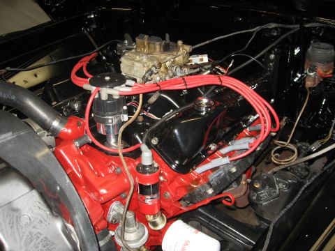1966 Ford F-100 - Close-up of an engine bay a red block, black valve covers, and bright red spark plug wires, suggesting recent work or a custom build.