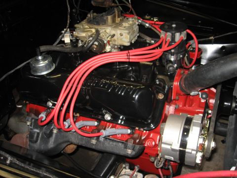 1966 Ford F-100 - Close-up view of a V8 engine, showing the carburetor, distributor, and spark plug wires.