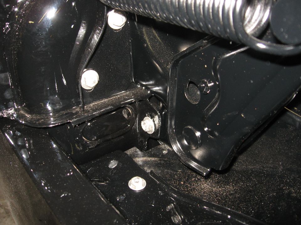 Black metal frame with bolts and a spring