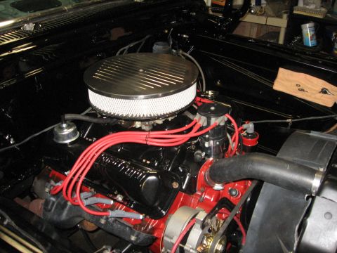 1966 Ford F-100 - Engine bay view showing a V8 engine with aftermarket air cleaner and red spark plug wires.