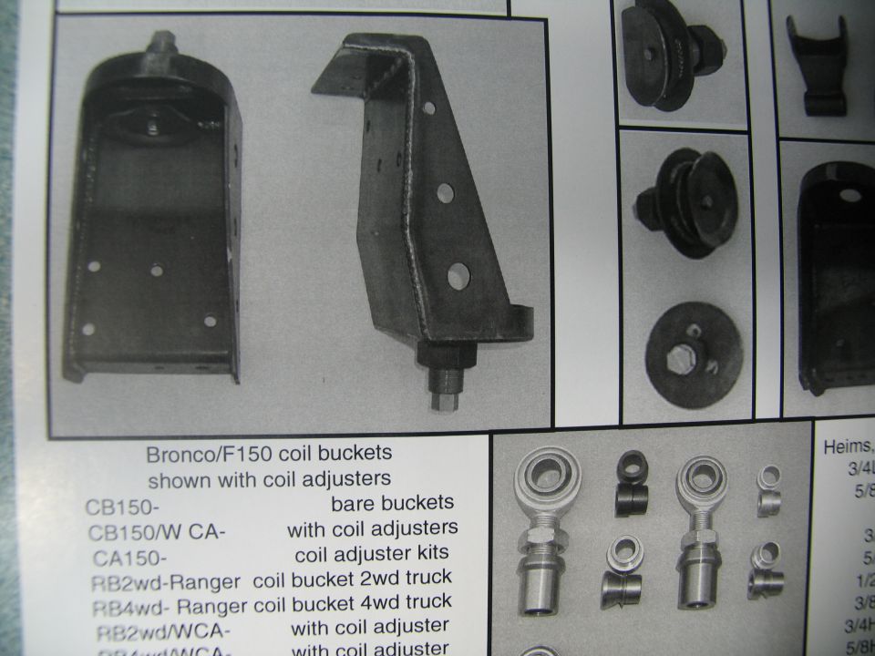 Close-up of metal brackets and other suspension components, with text labels indicating they are for Bronco/F150 coil buckets