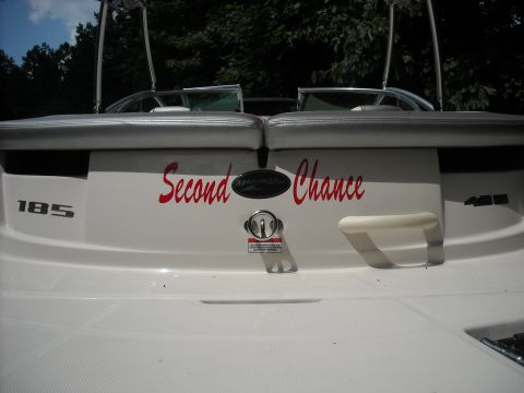 1979 Ford F-150 - The rear of a white boat shows the name "Second Chance" in red script along with model numbers.
