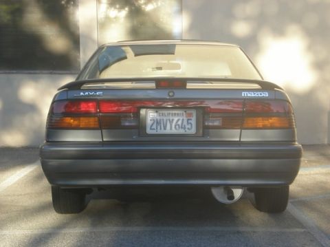 1989 Mazda MX-6 - The rear of a 1989 Mazda MX-6 is shown, its distinctive taillights and license plate.