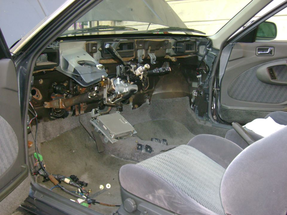 1989 Mazda MX-6 interior with dashboard removed, showing exposed wiring and components