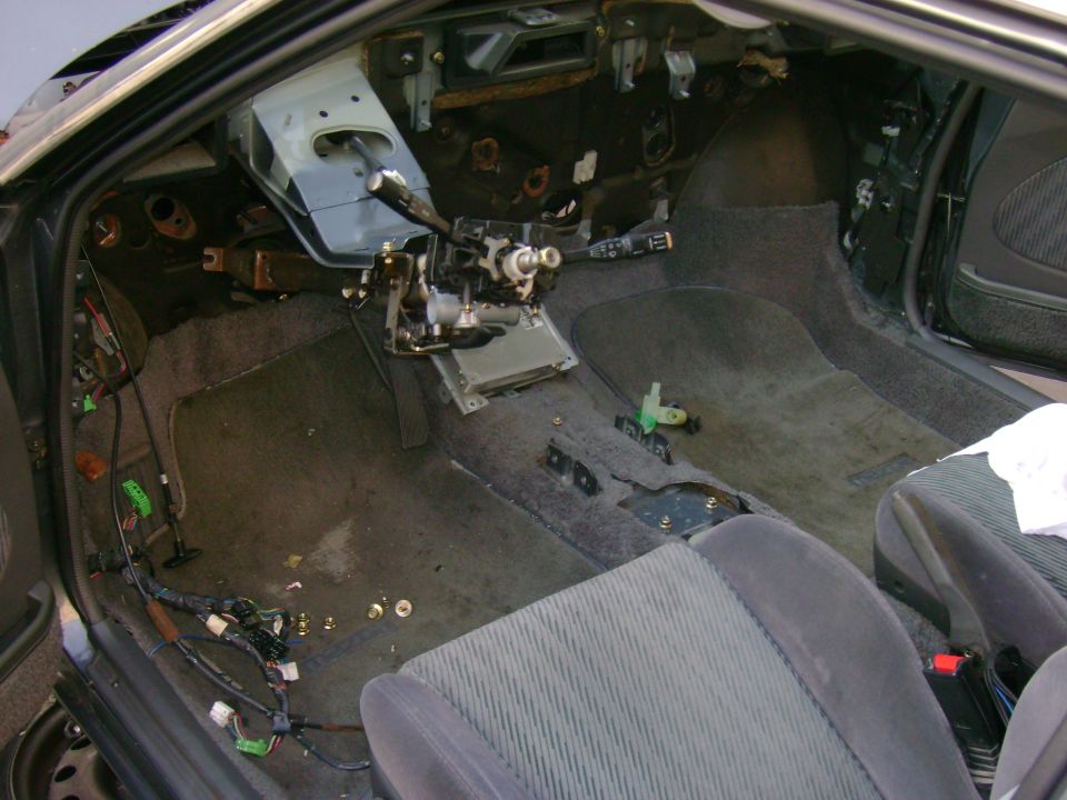 Interior of a car with dashboard removed and wiring exposed