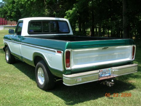 1979 Ford F-100 - This 1979 Ford F-100 pickup truck features a distinctive green and white two-tone paint scheme and a polished chrome rear bumper.