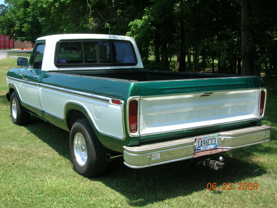 Rear view of a 1979 Ford F-100 pickup truck, green and white two-tone paint, chrome bumper