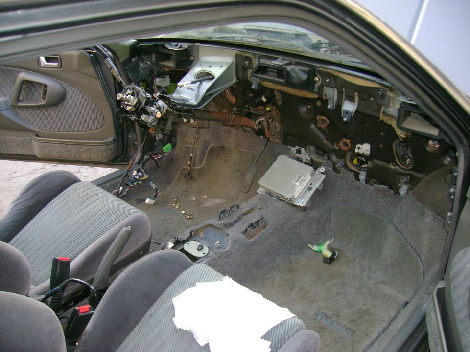 Interior of a 1989 Mazda MX-6 with dashboard removed