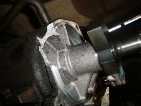 1986 Ford Bronco - A close-up view of a vehicle's drivetrain component, possibly a transmission or differential housing, with visible wear and oil.