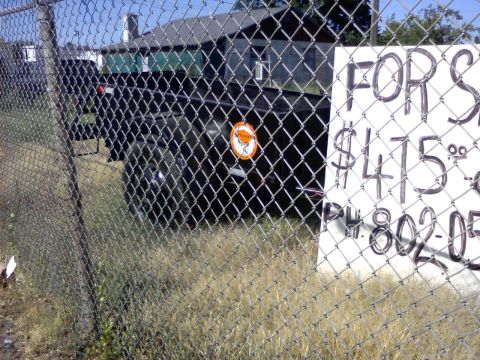 1989 Ford Bronco - A trailer is for sale for $475, with a phone number visible on a sign.