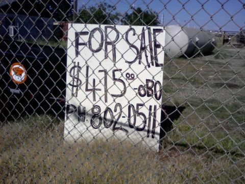 1989 Ford Bronco - A handwritten sign advertises an item for sale at $475 or best offer, with a phone number provided for inquiries.
