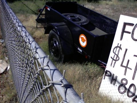 1989 Ford Bronco - Utility trailer for sale, priced at $475, with contact information visible on a sign.