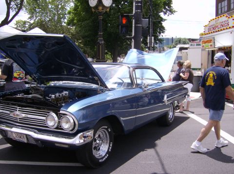 1970 Ford Ranchero - A blue 1960 Chevrolet Impala is displayed with its hood open at an outdoor car show.