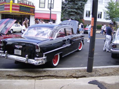 1970 Ford Ranchero - A classic black 1955 Chevrolet Bel Air is displayed at an outdoor car show event.