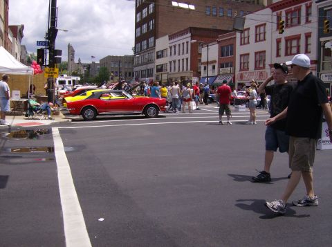 1970 Ford Ranchero - Classic cars on display during a street event with onlookers.